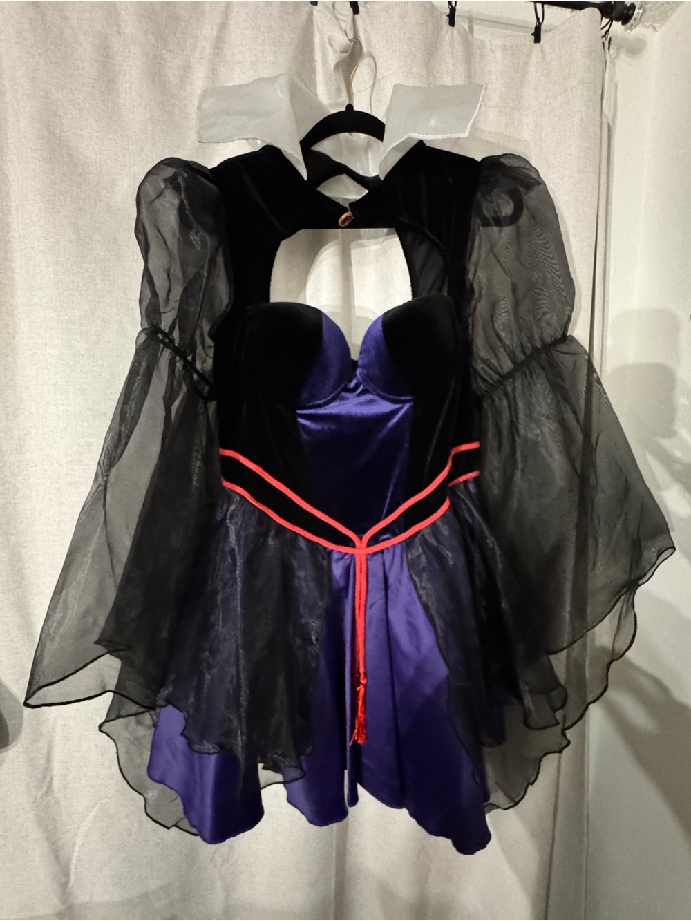 Dolls Kill One Bad Apple Costume. Black and Purple Witch Costume with Red Trim